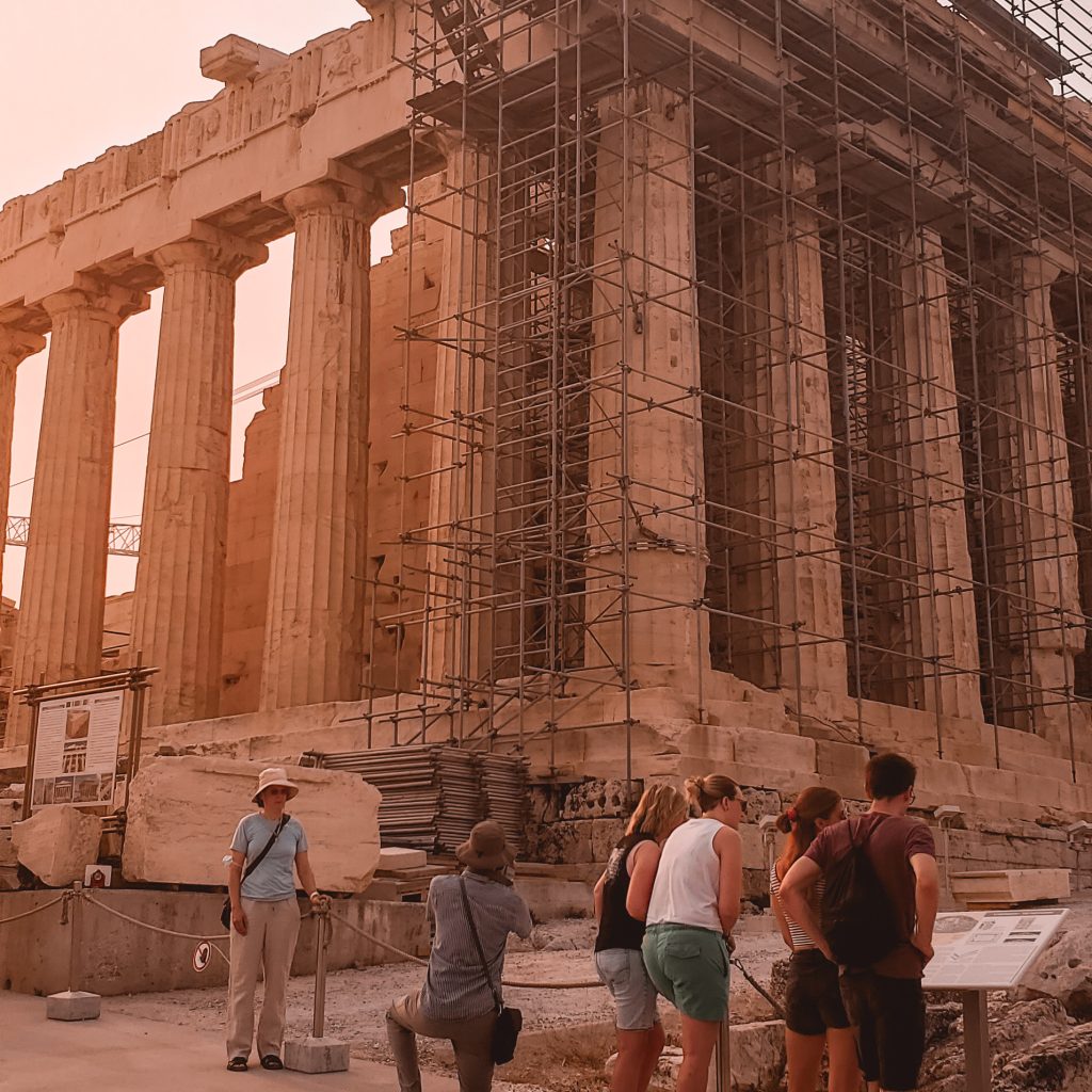 Acropolis with people reading the plaque