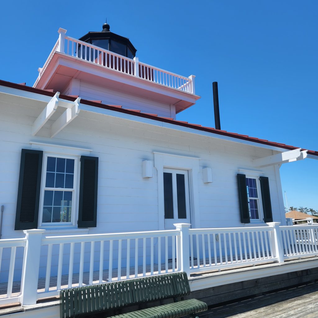 beautiful white lighthouse with a boardwalk in manteo