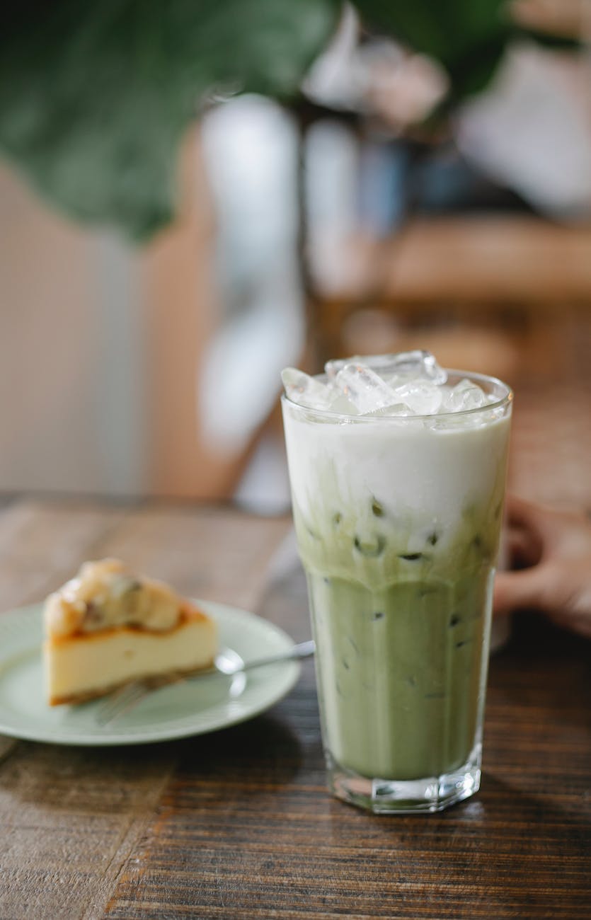 fresh matcha latte served on table with sweet pie
