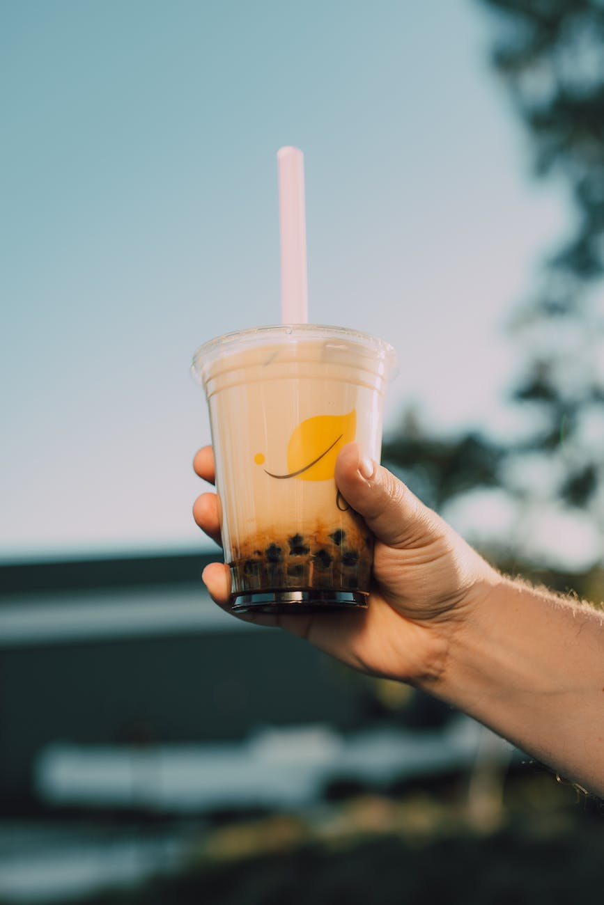 a person holding a cup of bubble tea