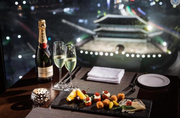 champagne and delicious side dishes with a view of a palace gate in seoul
