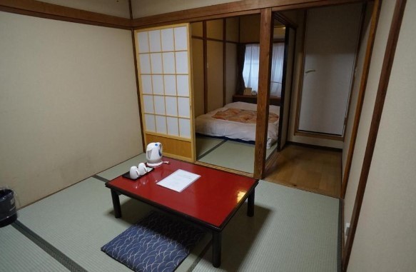 small japanese tyle room with sliding doors at katsutaro ryokan