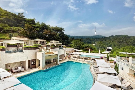 luxury hotel in seoul with a large pool with a view of the n seoul tower