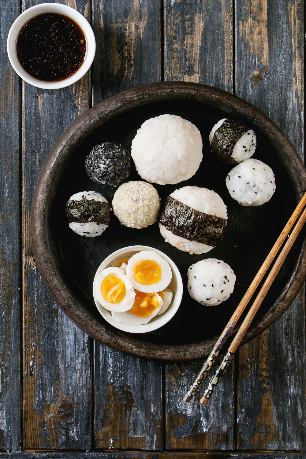 japanese rice balls with poached eggs and chopsticks