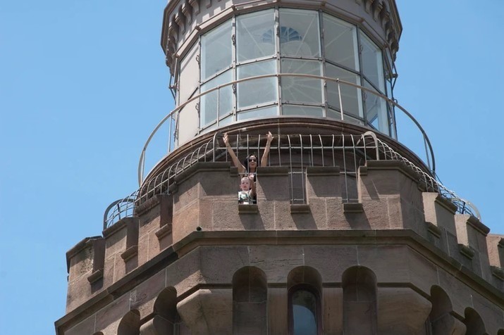 woman and kid on top of lighthouse tower in new jersey, marked as a historical place in new jersey