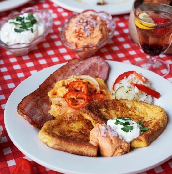 a plate of bacon, eggs, and french toast at a breakfast spot in tokyo