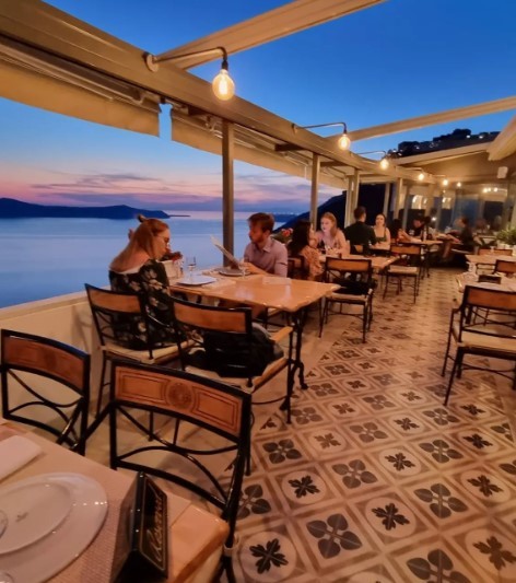 people sitting at Santorini restaurant with a view at sunset