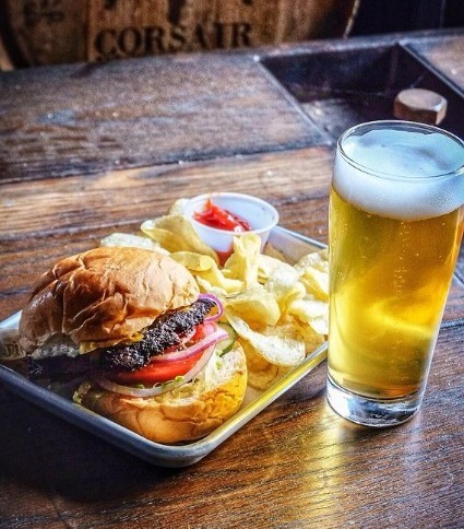 glass of beer with a burger and chips