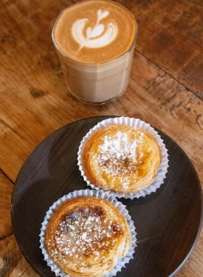 two powder pastries with coffee