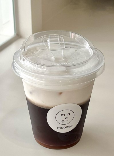 black tea latte on white table inside seoul cafe