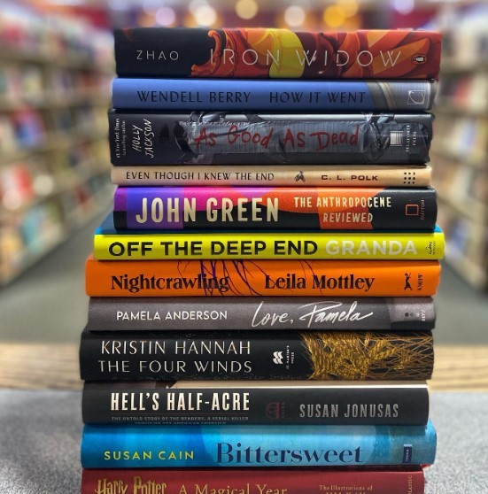 a stack of colorful adult books