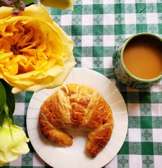 yellow flowers with croissant and coffee at greenbriar
