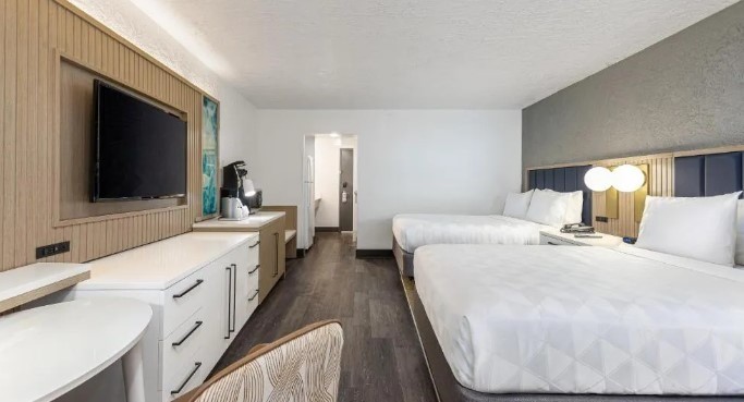 two queen size beds with flat screen tv and spacious desks in all inclusive resort in florida