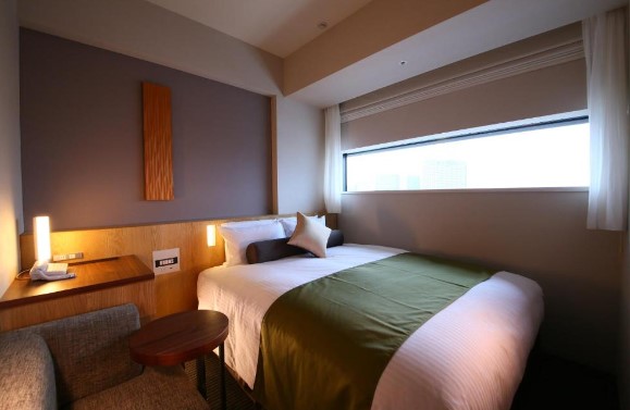 traditional Japanese style hotel room with wide window overlooking city