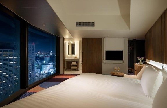 boutique hotel room in shinjuku lit up at night with city lights