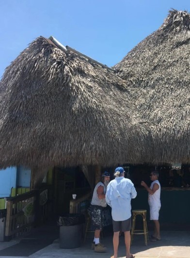 a tiki hut with people hanging out in florida