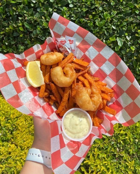 fried shrimp with sweet potato fries in a basket