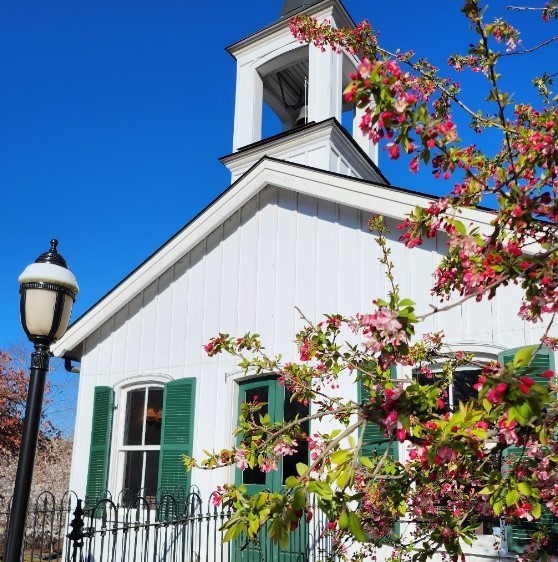 white and green church with pink flowers