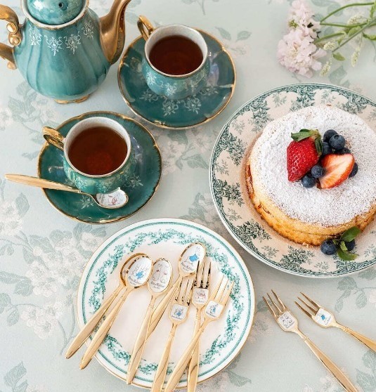 fancy tea set with delicate blue designs and soft pancakes