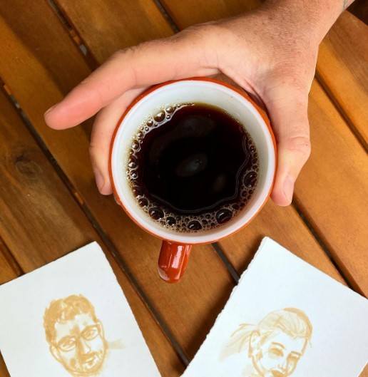 dark roaster coffee in a red cup with two drawings of people