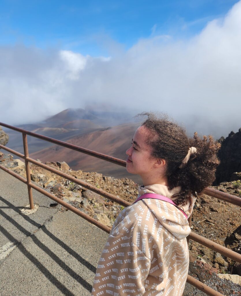 standing behind railing showcasing view of volcano crater in Maui