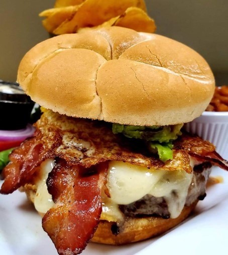 avocado, bacon, cheese, and egg burger at the feast restaurant in anna maria island in florida