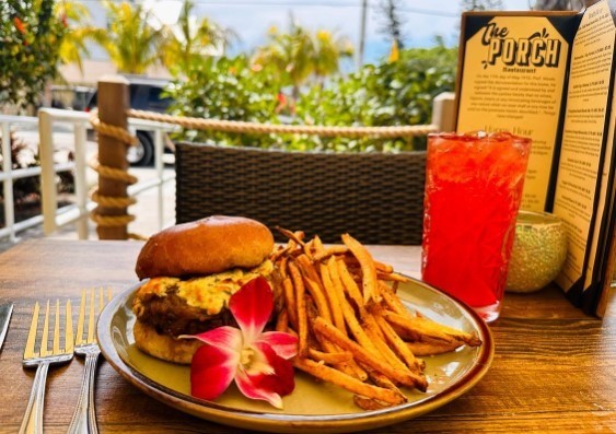 caramelized onion burger with tropical flower and fries at the porch restaurant