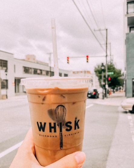 iced coffee with whisk branding outside in street