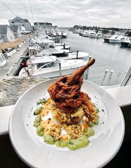 fried quail with couscous and herb vinaigrette with boat harbor view