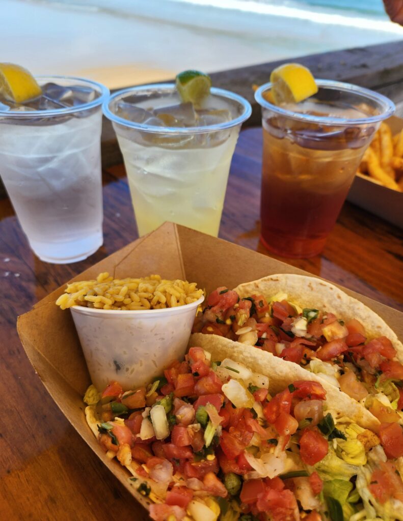 two fish tacos with rice and a margarita at fish heads on the pier with ocean view