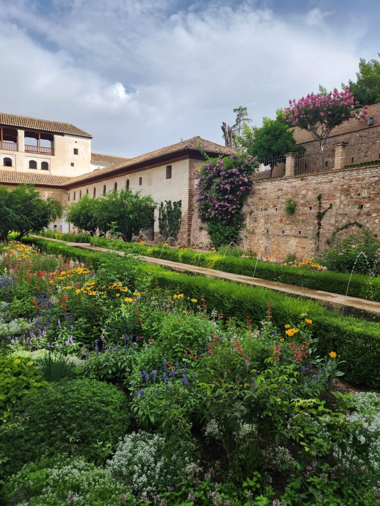 generalife gardens with islamic building and flowers