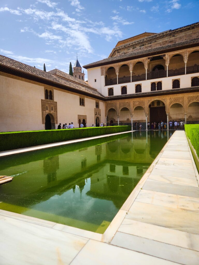 rectangular green pool with islamic building at the granada