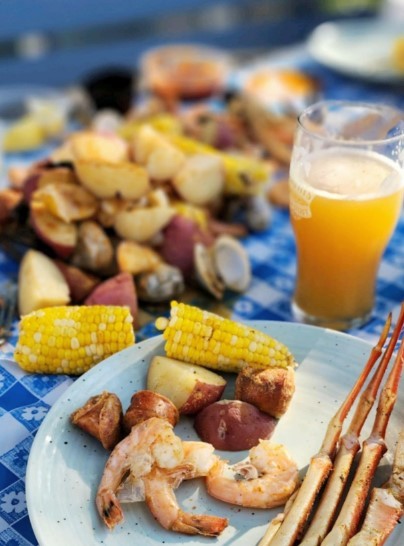 crab legs, corn, and potatoes with beer at boil company in obx