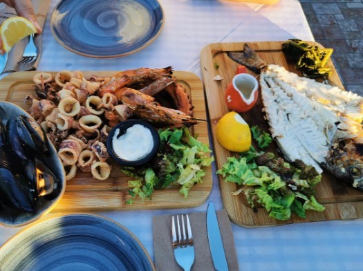 two large seafood platters with lettuce at a greek tavern in santorini