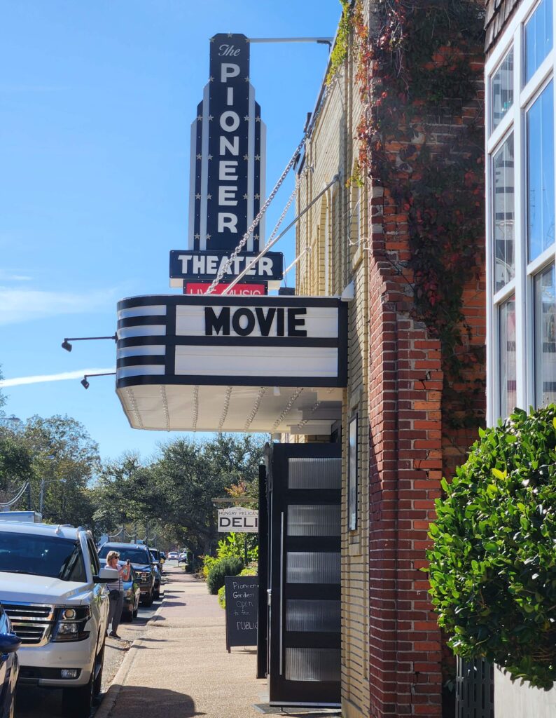 pioneer theater with cars parked on street in manteo