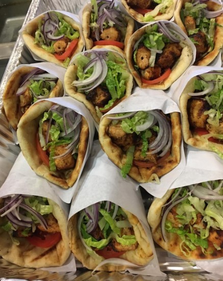 stacks of gyros wrapped in paper