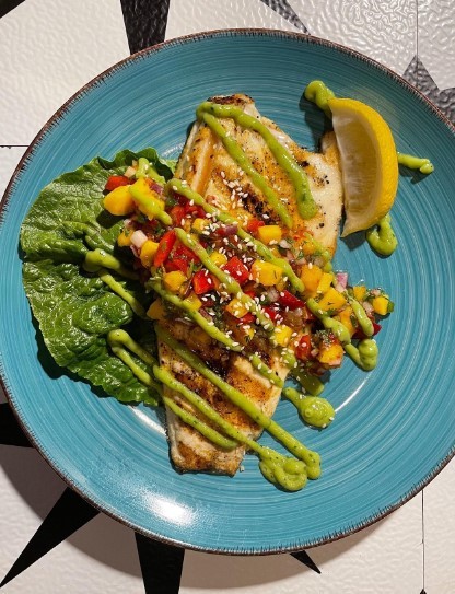 grilled sea bass with mango sauce and avocado