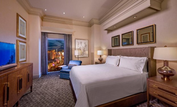 a large bed with a view of the strip